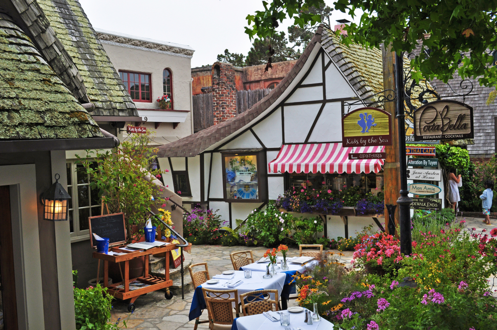 a shop that looks like a cottage and a restaurant with outdoor seating in Carmel, California