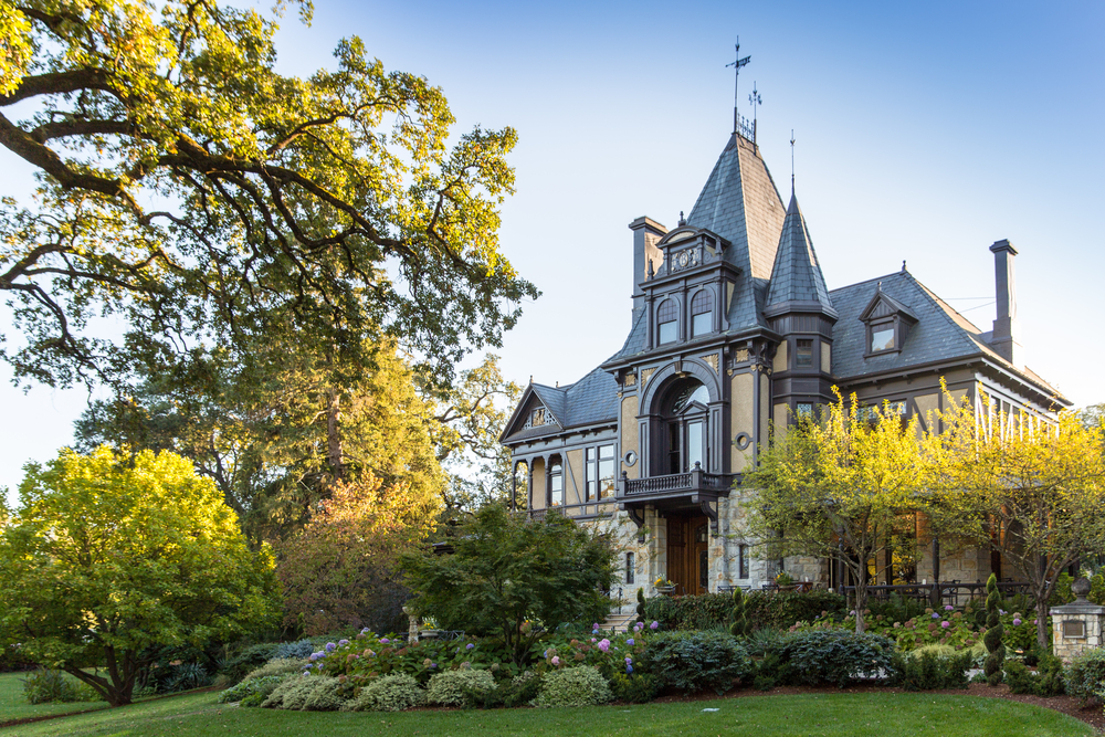 lush grass and trees in front of Beringer Vineyards historic Rhine House in St. Helena, California