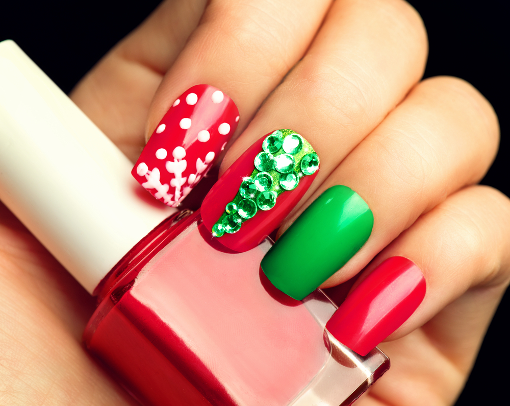 Winter Holiday style bright Manicure with gems Christmas tree and snowflakes. There is a Christmas tree and snowflakes. 