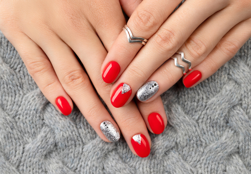 Woman's hands with fashionable red manicure. Christmas new year nail design. Festive Christmas Nail Ideas 