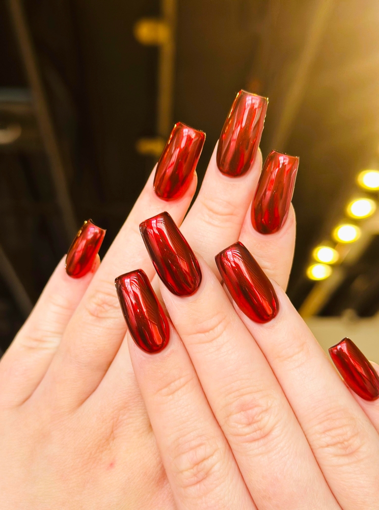 Woman with Red gold nails design. Manicure. 