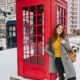 woman standing in front of post box in london in January