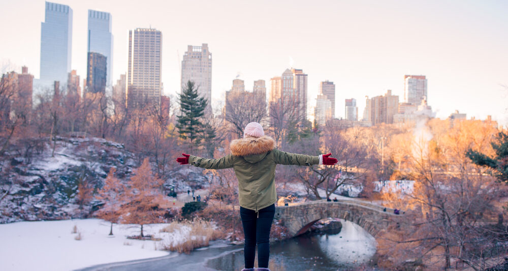 woman standing in front of buildings in NYC in January