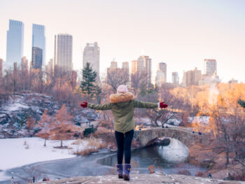 woman standing in front of buildings in NYC in January