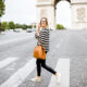 woman standing at crosswalk in paris wearing a cute striped top