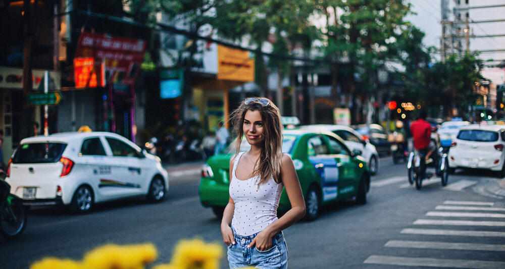 woman standing in a white shirt and jeans in NYC in the summer