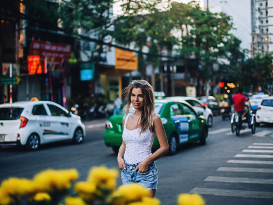 woman standing in a white shirt and jeans in NYC in the summer