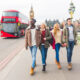 A group of friends in jeans, ankle boots, jackets and sweaters walk down the city's streets, not worrying about what to wear in London in February, enjoying the Double Deckers behind them and Big Ben in the background.