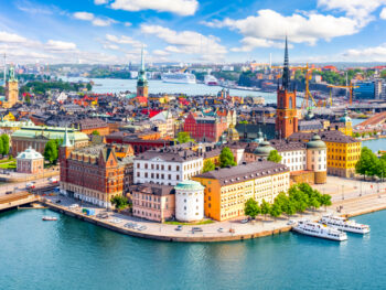 city skyline view of stockholm sweden with beautiful blue river and buildings and blue sky with white clouds