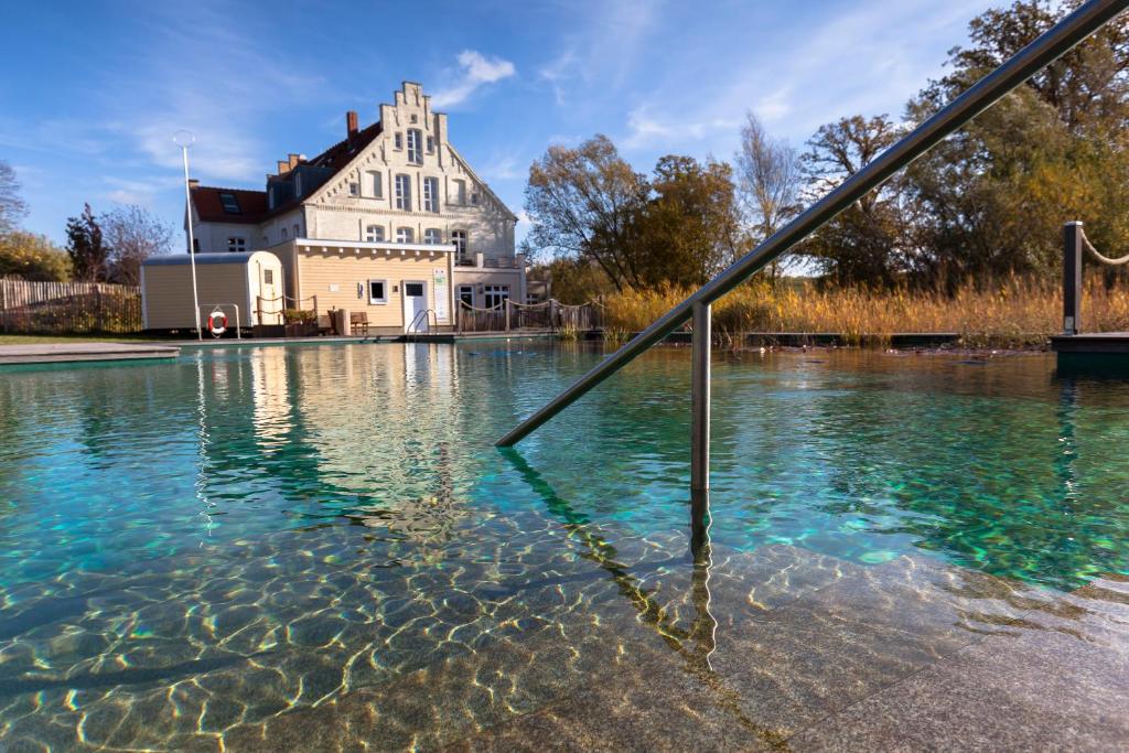 A pool with a building in the background. 