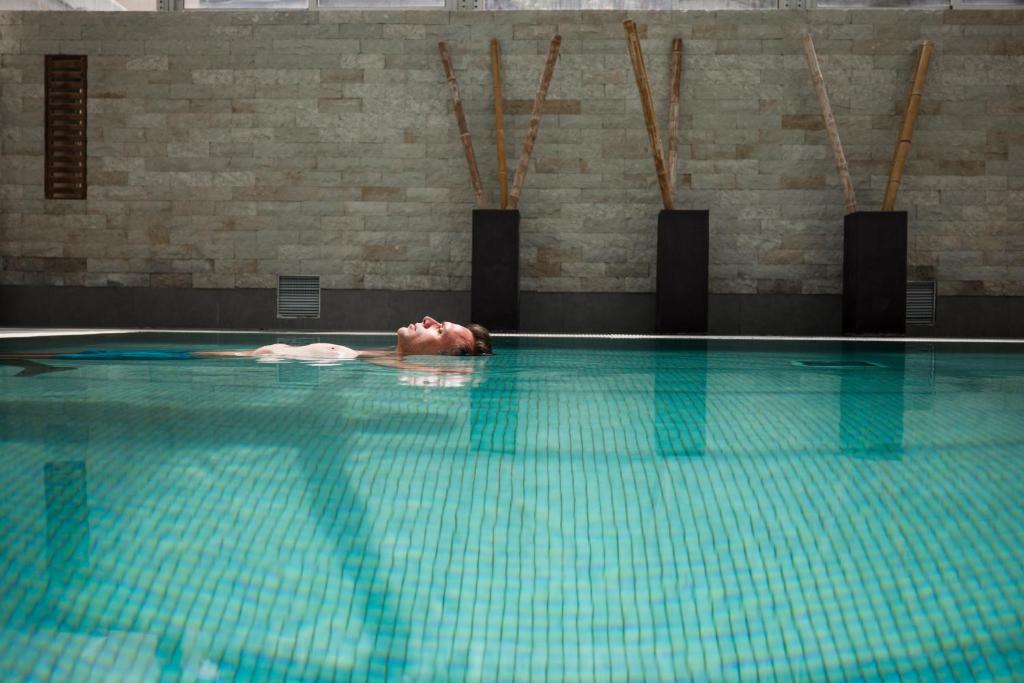 view of person floating in a spa pool in one of the best spa resorts in Europe. 