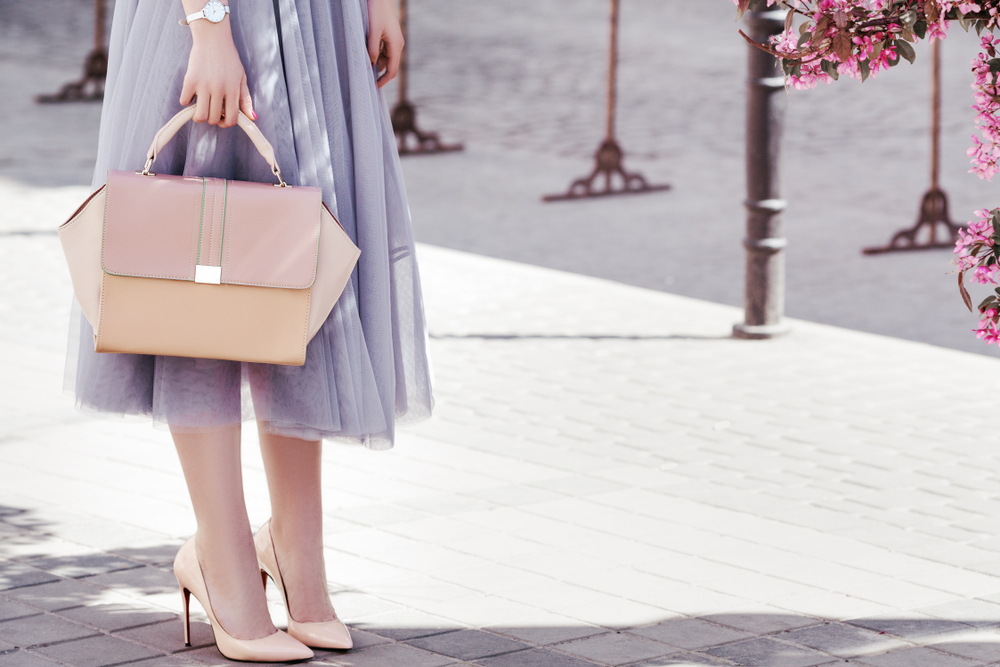 A woman wears a purple skirt and heels-- although heels are NOT recommended when wondering what to wear in Europe in spring, especially if you'll be doing a lot of walking. 