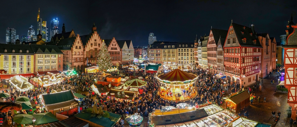 a large christmas market in europe with tents and a carousel, one of the top destinations for a 40th birthday trip in the winter 