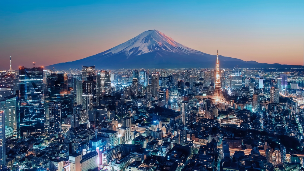 mountain in the background, a city in the foreground with lights on at night, 40th birthday trip ideas