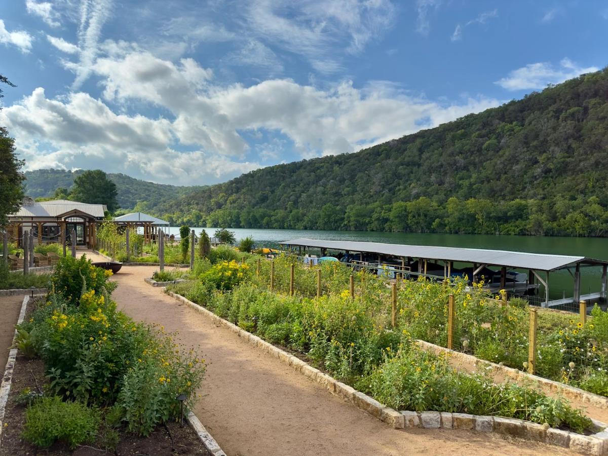 The outdoor view of Lake Austin Spa Resort overlooking the river with rolling hillside and gardens