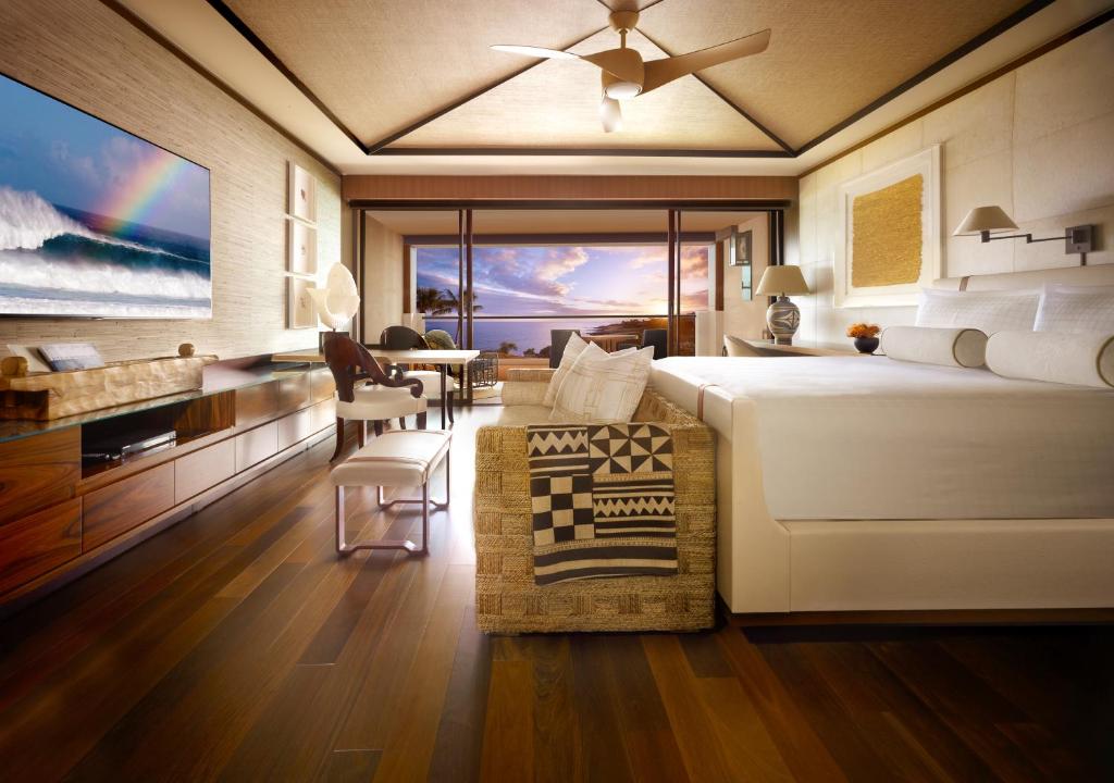 The wooden floor room with ceiling with large window overlooking the ocean  at sunset