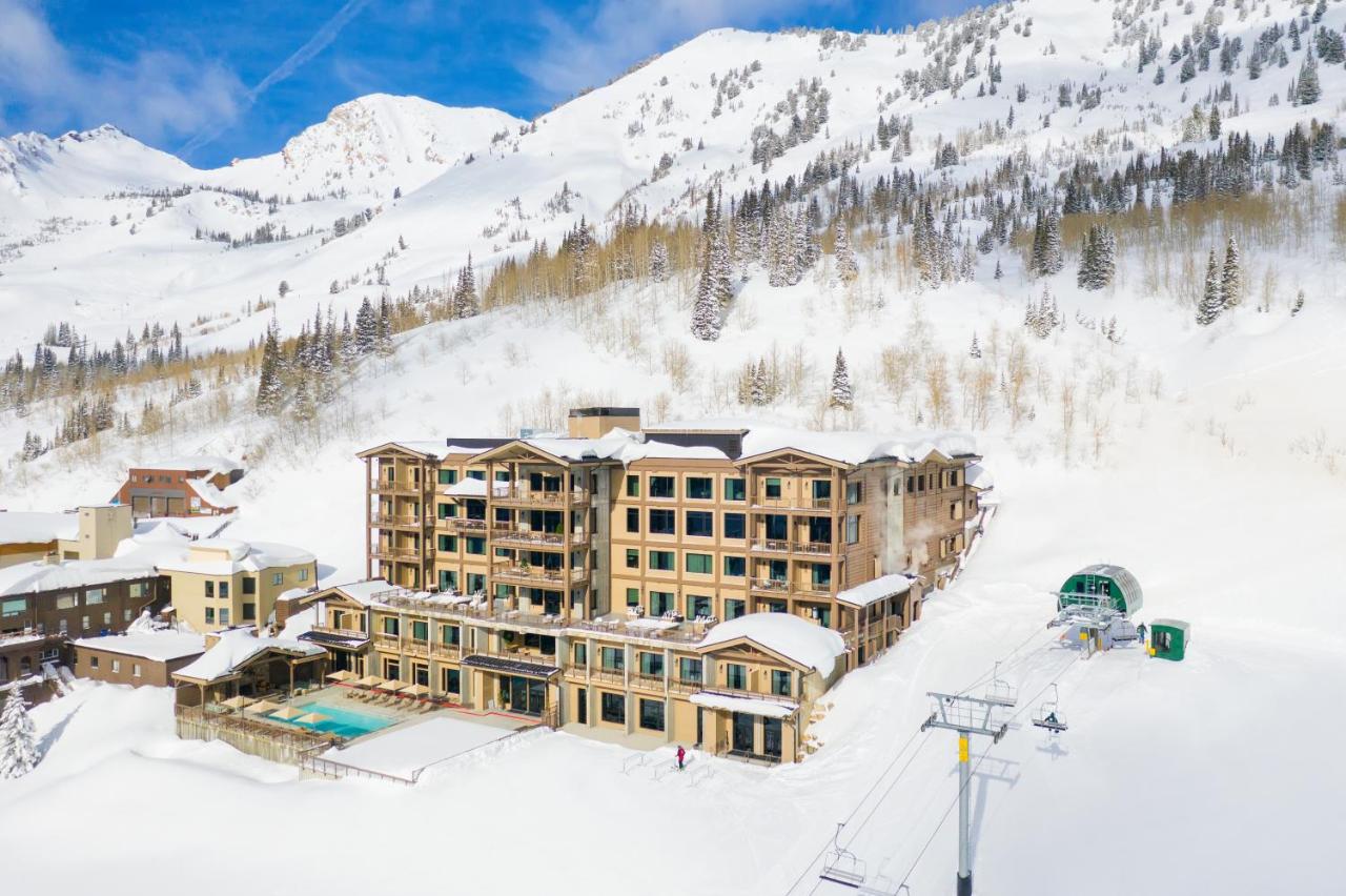 The snow covered mountain surround one of the best spa resorts in the USA Snowpine Lodge in Alta with outdoor pool and ski in ski out at winter time