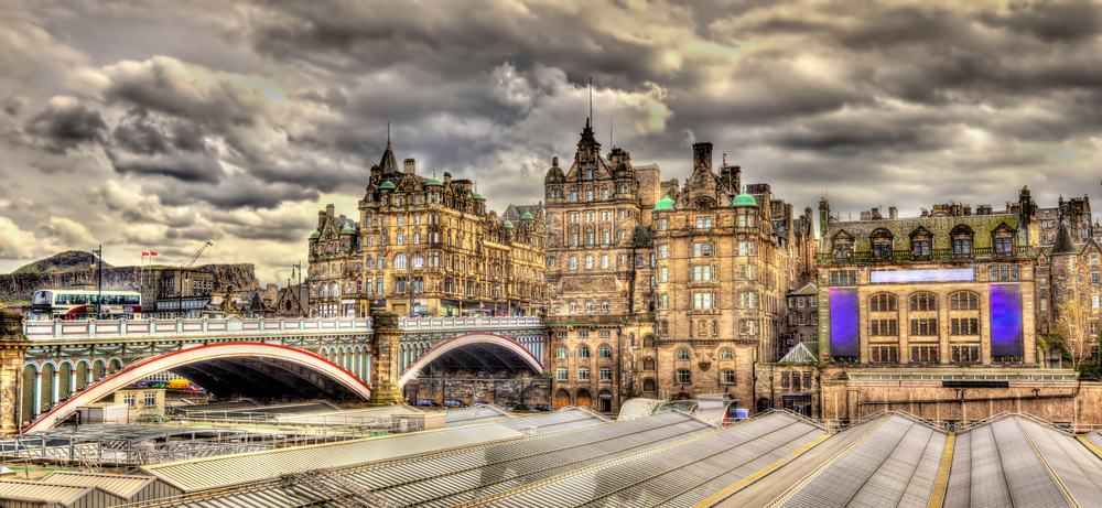 the iconic Waverly station in Edinburgh with striking architecture and train tracks through center of town 